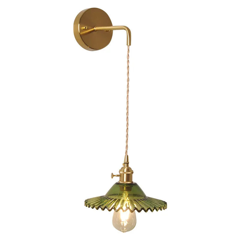 Retro brass wall lamp with lotus-shaped glass shade in choice of colours, mounted on a wall.