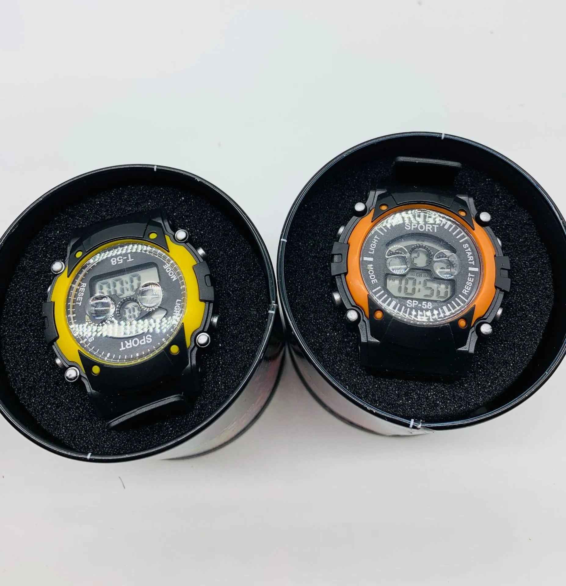 Children's digital sports watch with silicone strap and plastic case on wrist.