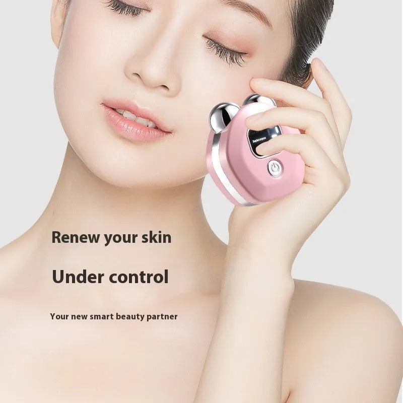 Portable white facial massage instrument with micro current and heated double-rollers on pink background