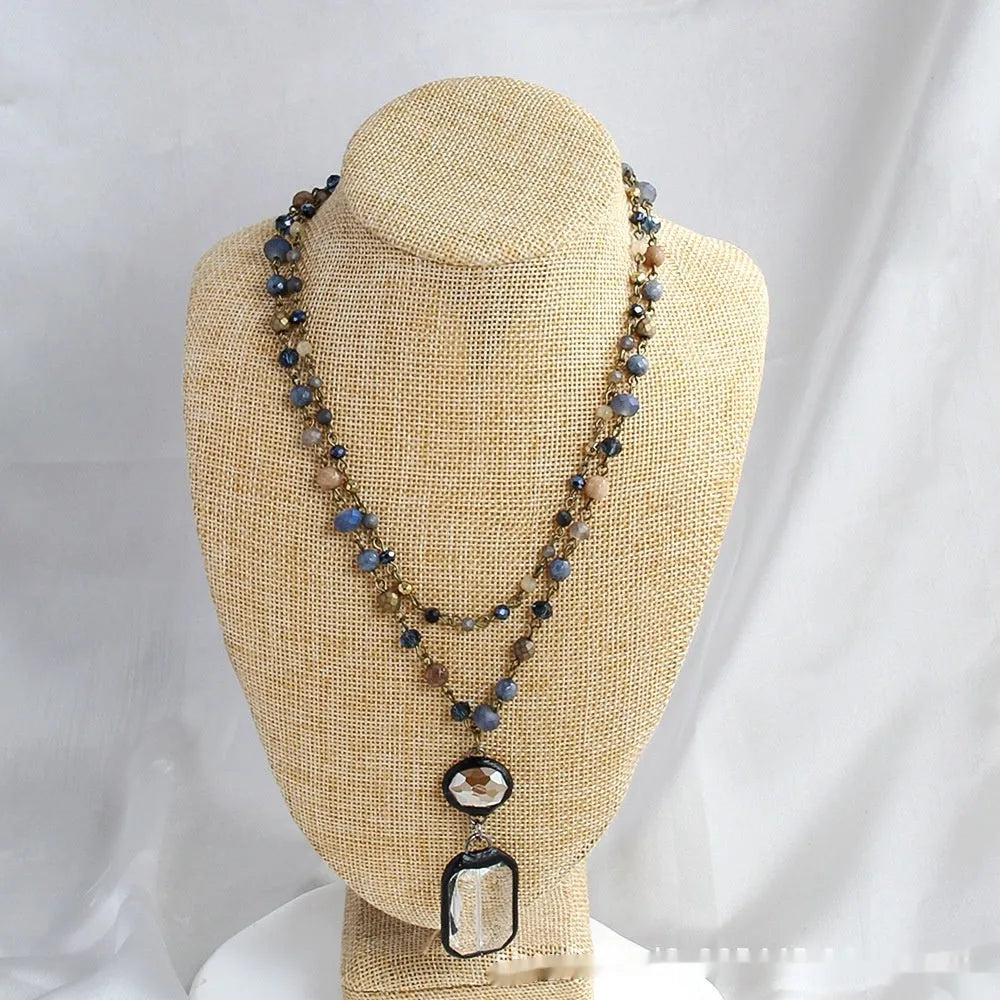 Tribal style two-layer chain necklace with glass and stone pendants in beige and blue colours