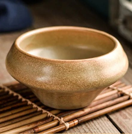Ceramic tall Japanese soup noodle bowl in a retro glaze colour on a wooden table.