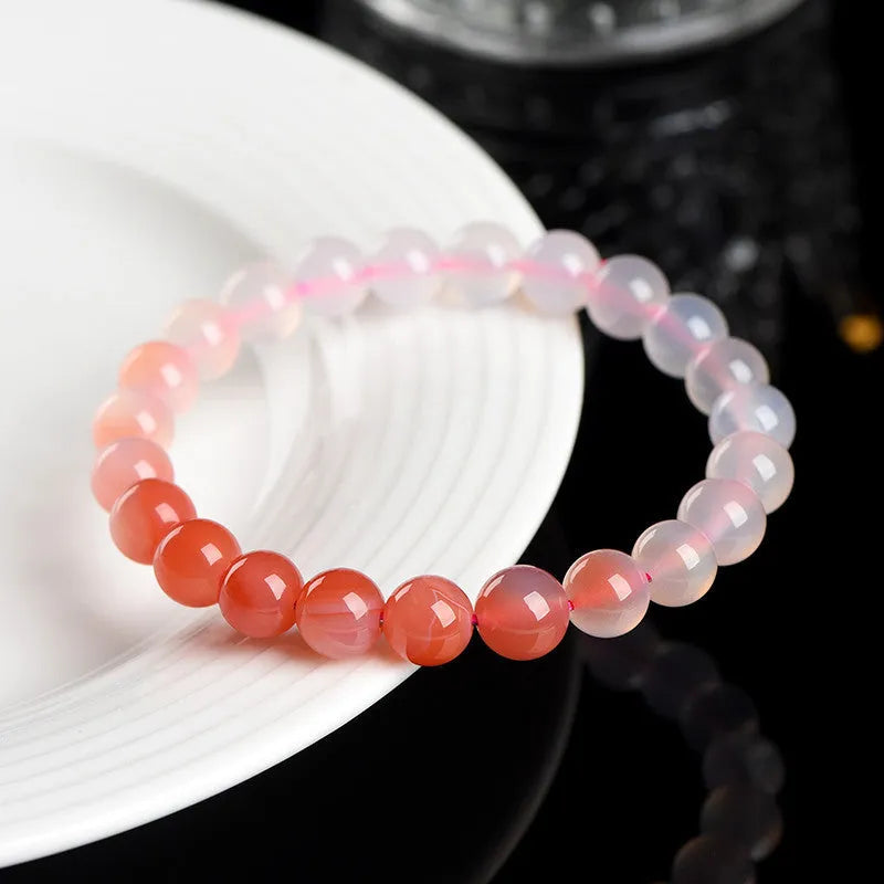 Natural gradient Yanyuan agate bracelet with geometry-cut beads on a wrist, showing salt source colour variation.