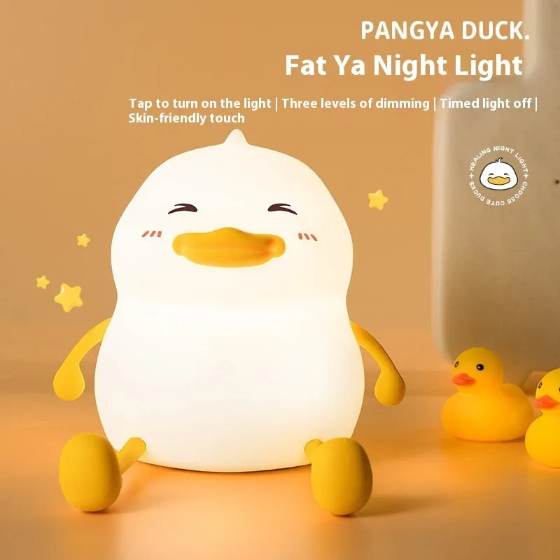 Chubby Night Light desk lamp showing soft glow, phone holder slot, and compact silicone design.