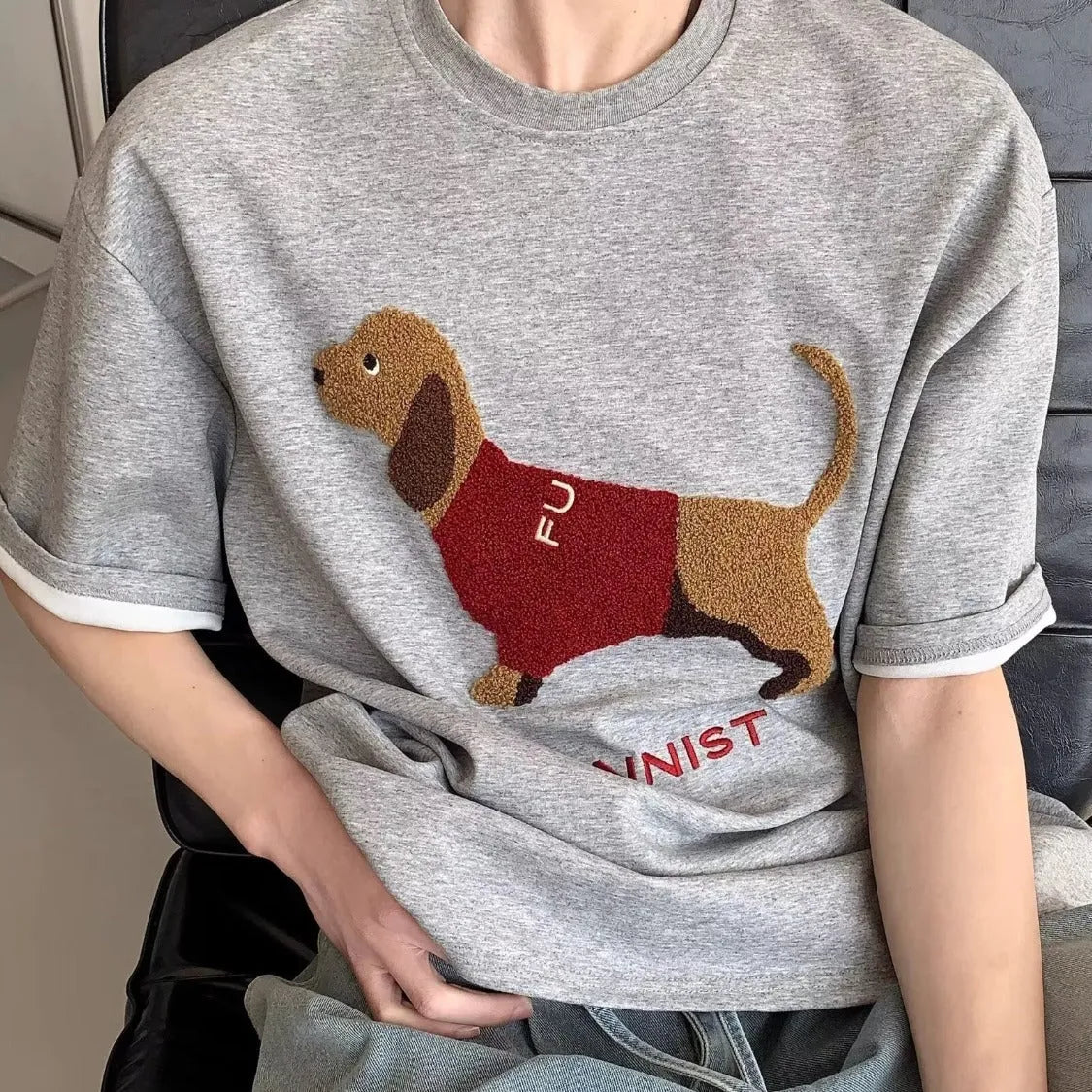 Grey men's cotton t-shirt with a detailed embroidered sausage dog design on the chest.
