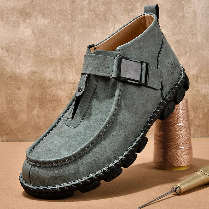 Men's black casual flat slip-on shoes with visible handmade stitching on the PU leather upper.