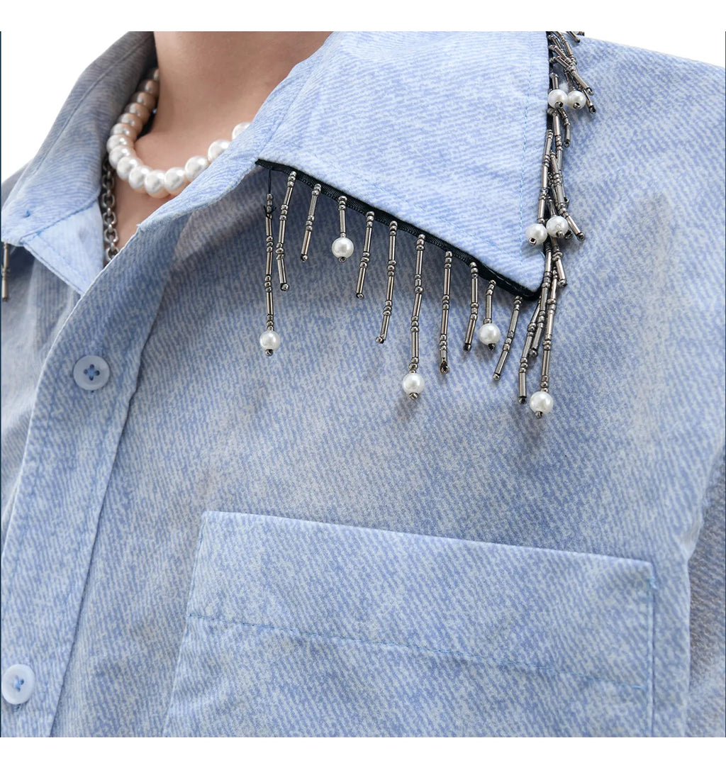 Man wearing a loose fit blue and white gradient short sleeve shirt with quilted details