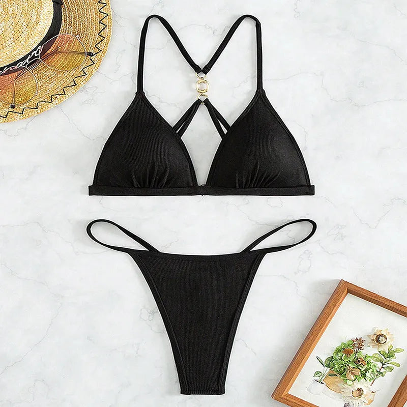 Black women's hollow backless split bikini with triangle top on a mannequin.