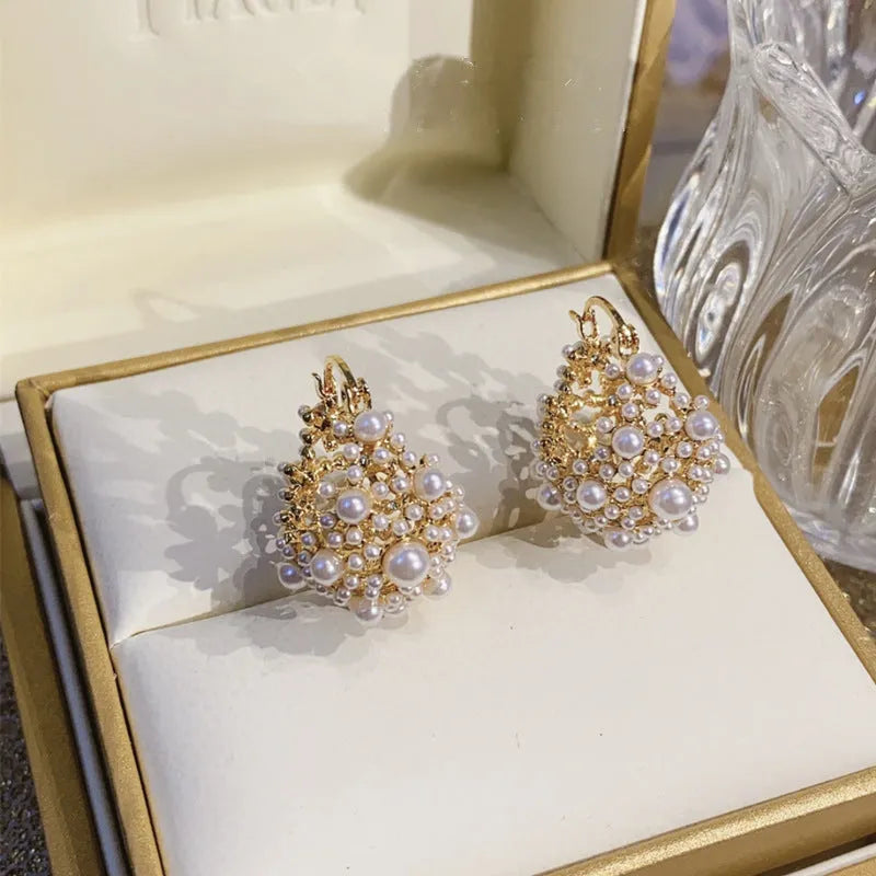 Gold-coloured copper wire flower basket earrings with small beads and inlaid pearls