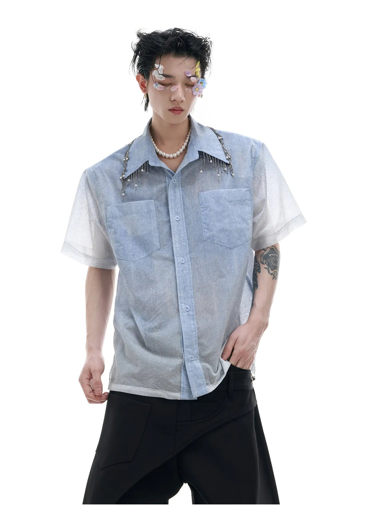 Man wearing a loose fit blue and white gradient short sleeve shirt with quilted details