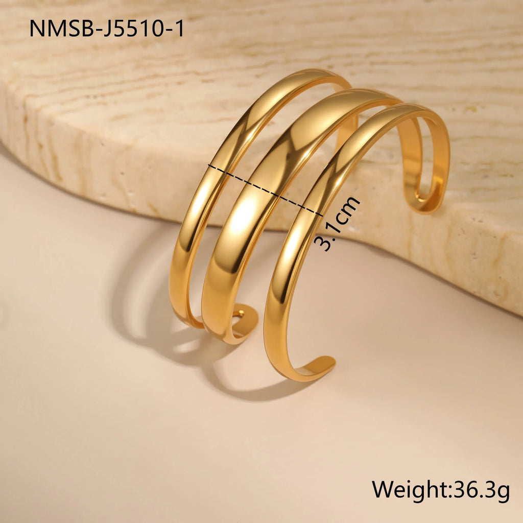 Women's stainless steel bracelet with geometric line design, shown in gold and steel finish options.