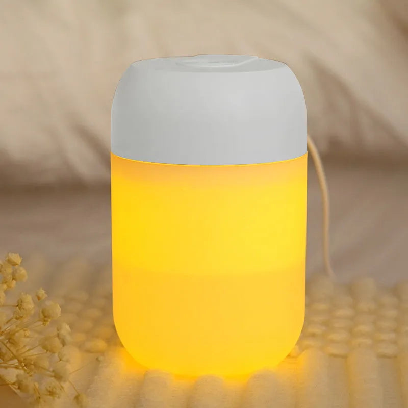 White cylindrical mini USB humidifier with aromatherapy function on wooden desk