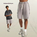 Men's loose-fit retro shorts in batik-washed cotton terry fabric, shown in a batik black colour.
