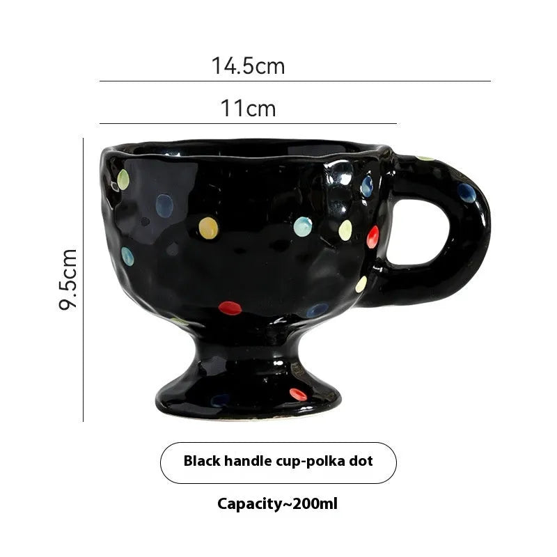 A handmade, irregularly shaped ceramic mug in a solid colour, shown on a table.