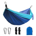 Blue nylon parachute cloth camping hammock hung between trees, showing its 270cm length.