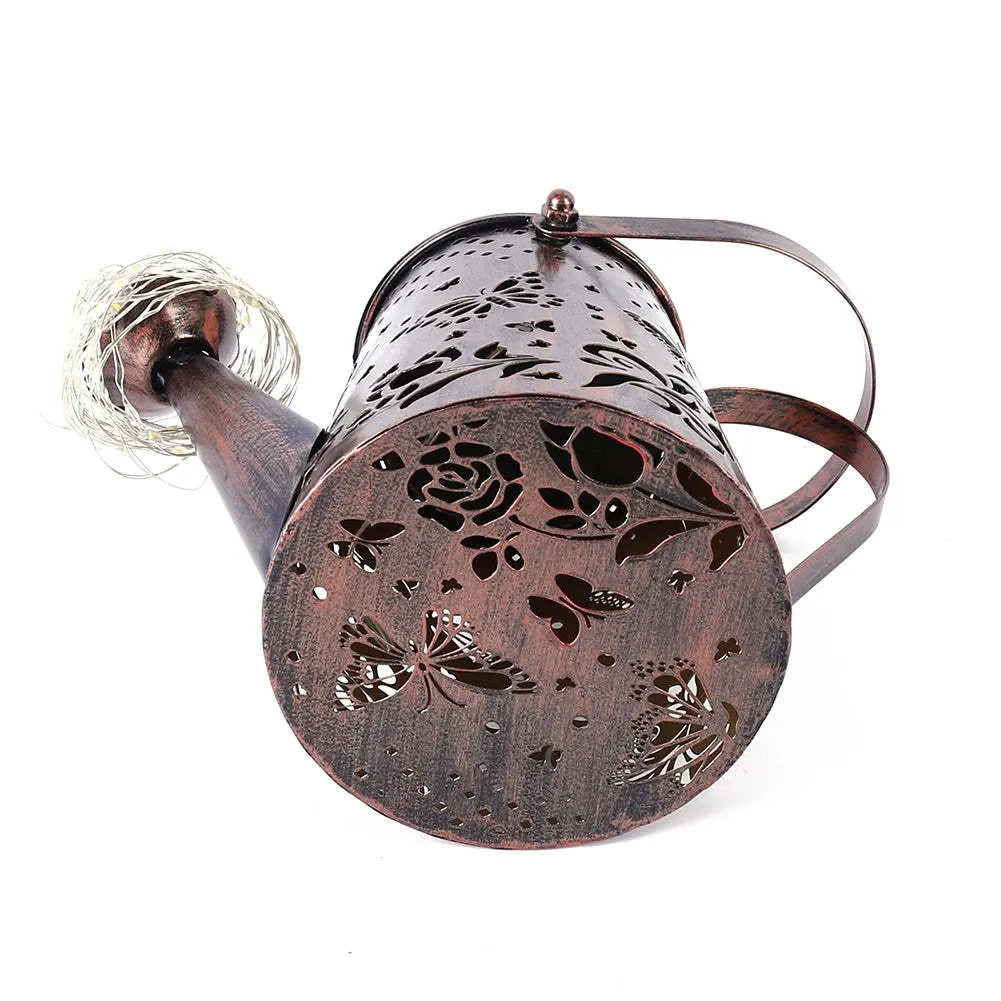 Solar-powered iron butterfly garden lamp with tapered silhouette and warm white LED light