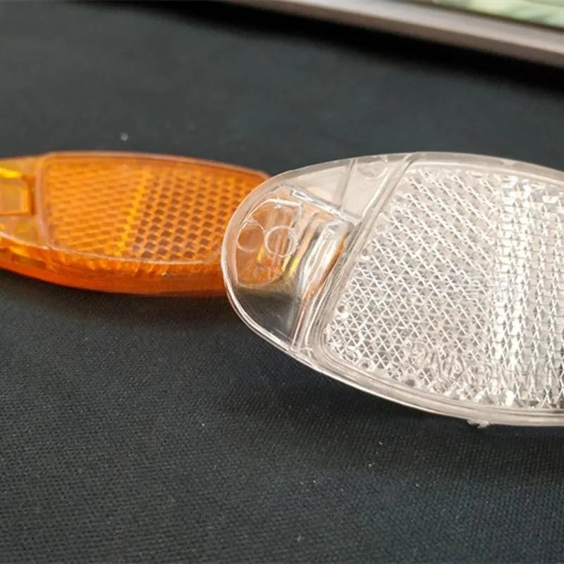 Bicycle plastic spoke reflector in white or yellow measuring 7.2cm length by 3.5cm width