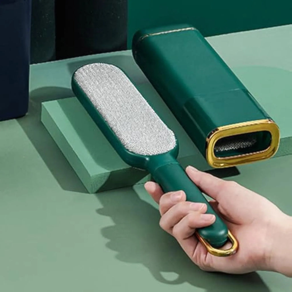 Blue reusable pet hair remover brush with a storage box base on a fabric sofa.