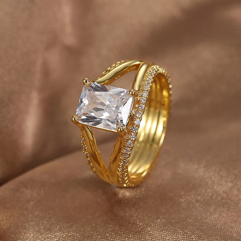 Gold-coloured geometric women's copper ring with a square zircon stone.