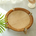 Natural brown woven rattan pet hammock with raised sides on a wooden floor.