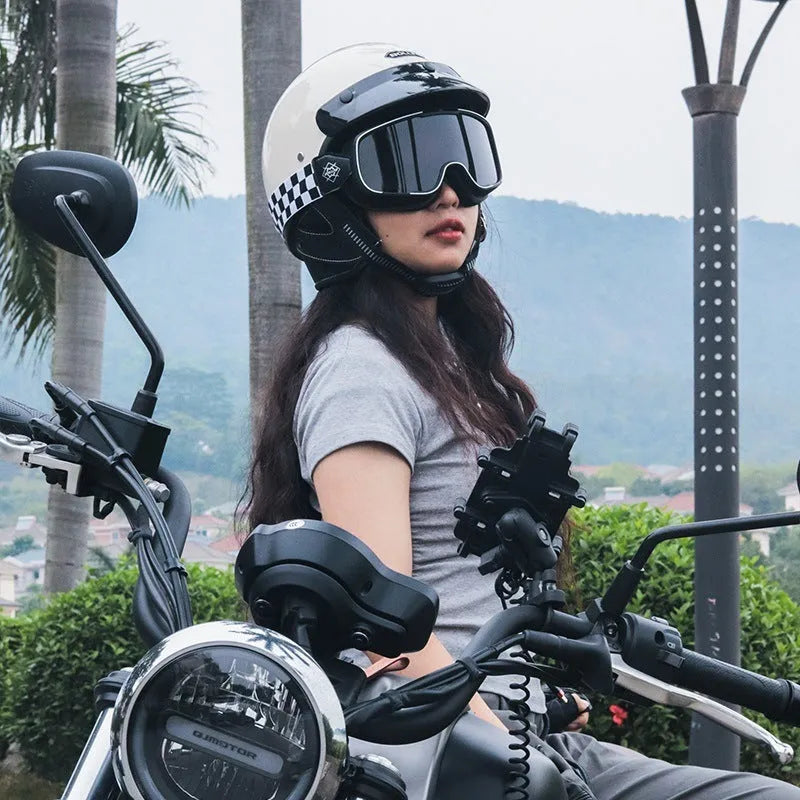 Retro style motorcycle helmet in matte black on a stand, showing classic biker design.