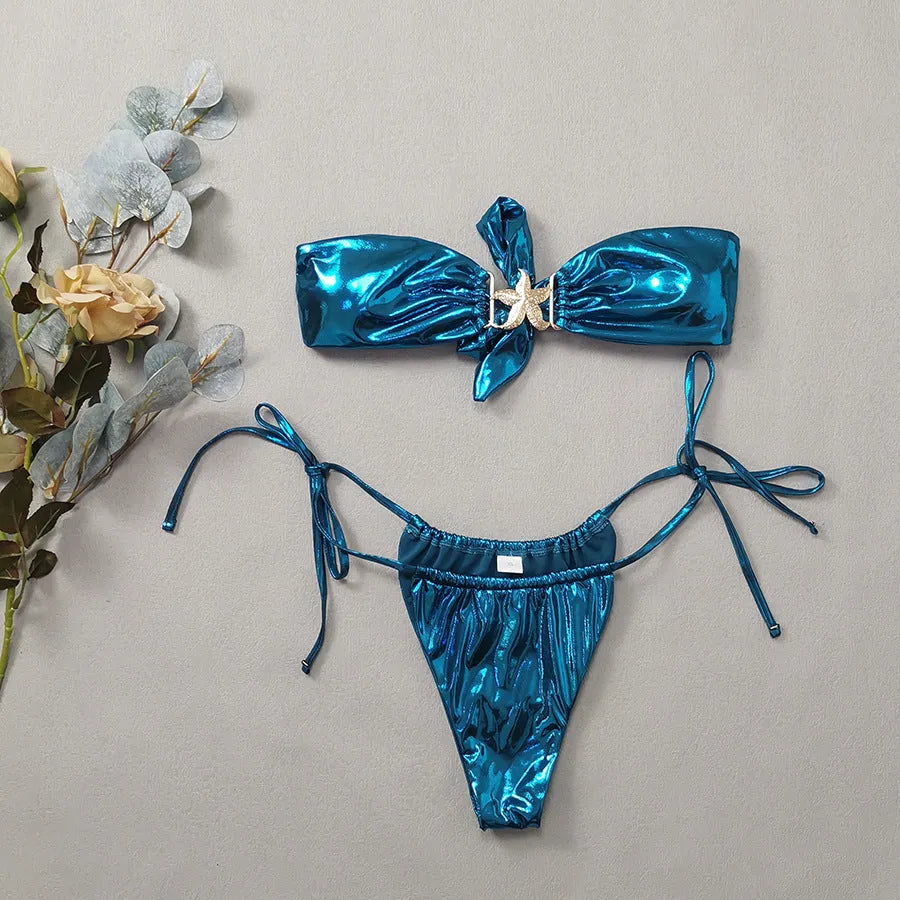 Women's glossy sapphire blue bikini set with gold starfish print on tube top and briefs.