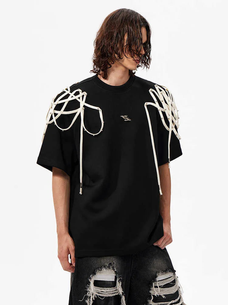 Black loose-fit short-sleeved T-shirt with padded shoulders and rivet ribbon detail.