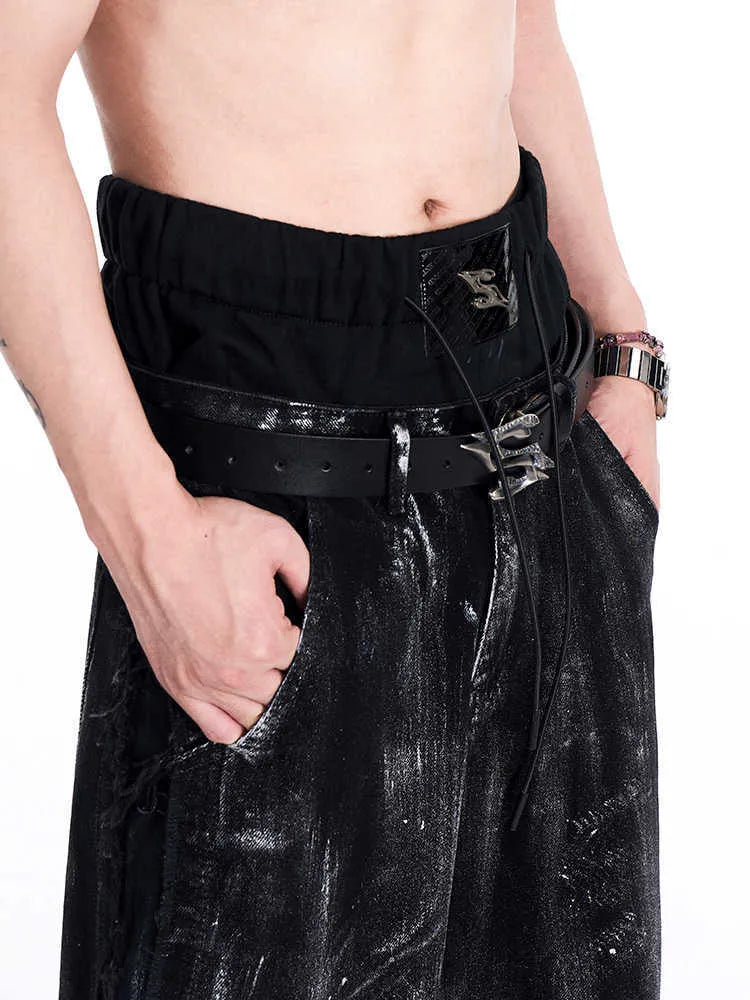 Black men's leather belt with metal letter detailing showing two-layer cowhide construction and adjustable buckle