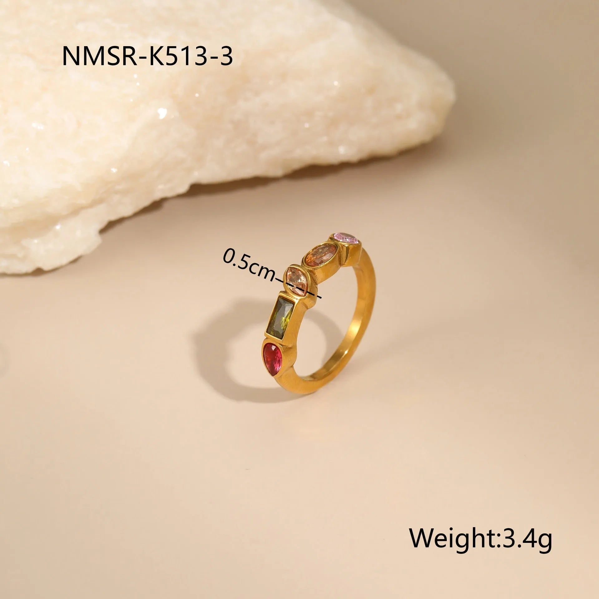 Geometric gold plated zircon necklace, ring, and earrings set on a plain background