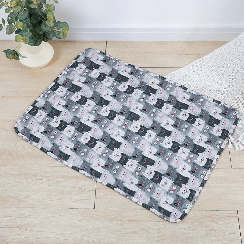 Reusable washable pet urine pad with colourful animal print design on cloth with waterproof base.