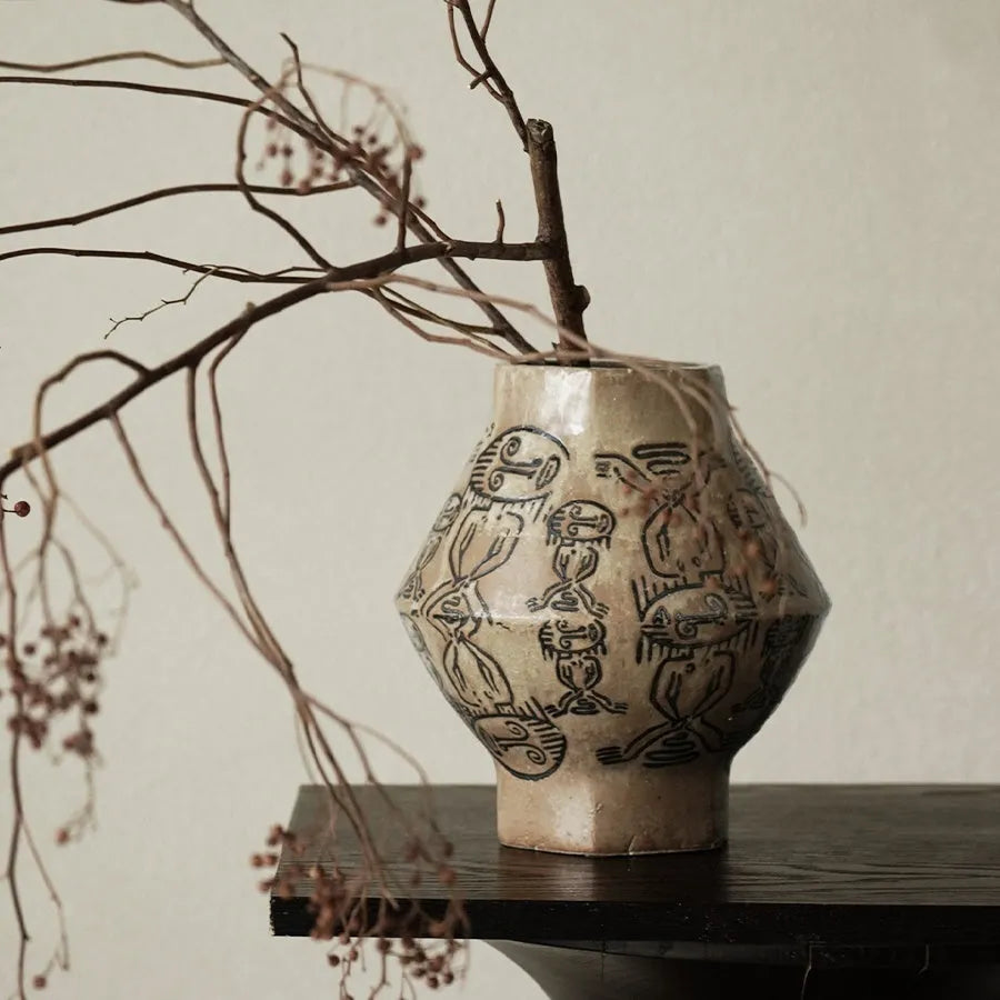 Ceramic vase with hand-painted vintage carved tribal totem art in religious symbolic patterns