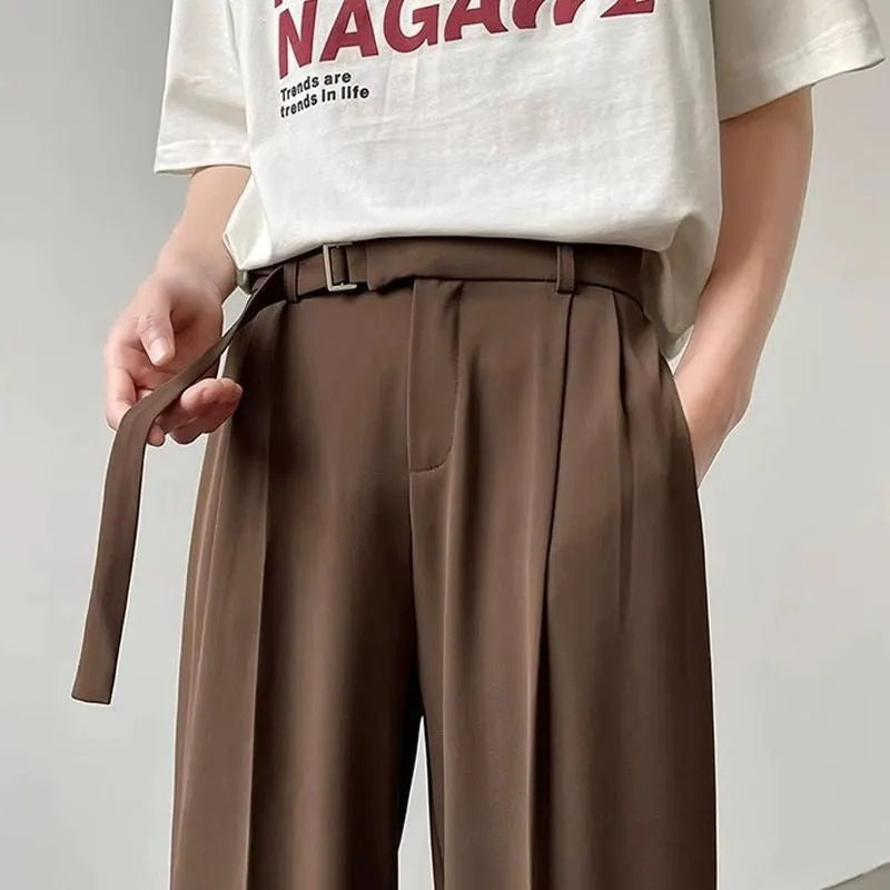 Black wide leg straight trousers with a loose fit on a hanger.
