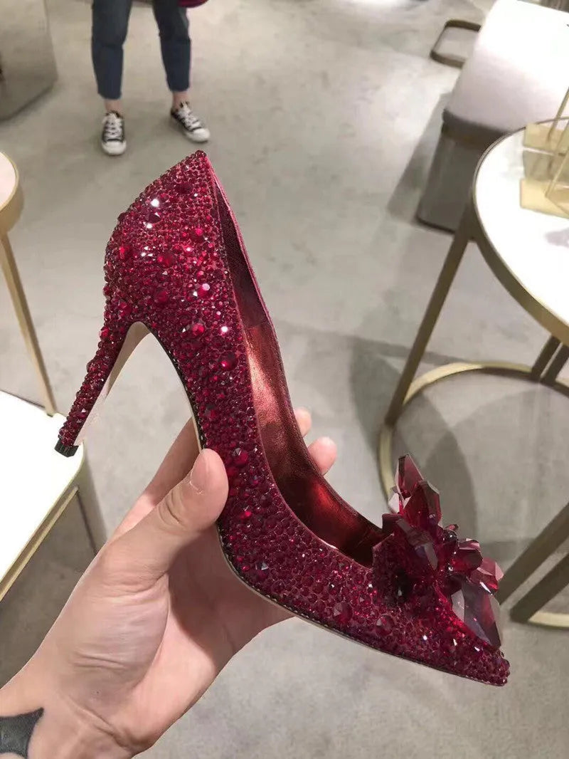 Women's gold pointed toe high heels with rhinestone details and stiletto heel