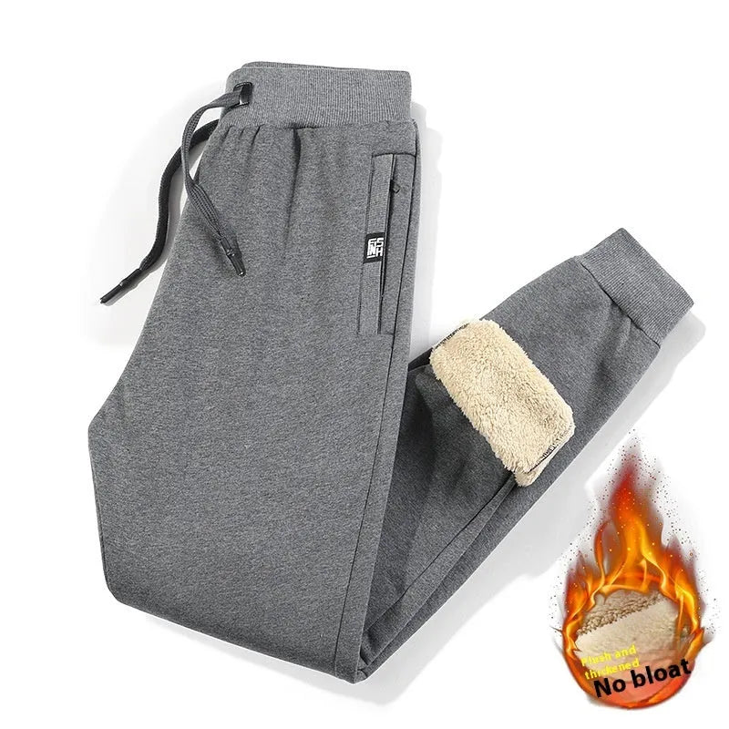 Men's grey fleece-lined cotton track pants in oversized style showing drawstring leg detail