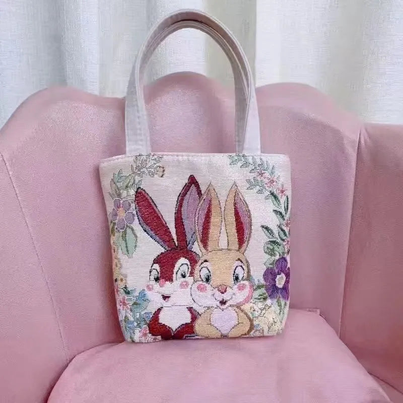 Double-sided gold wire embroidered canvas tote bag showing front and back design, available in multiple sizes and colours.