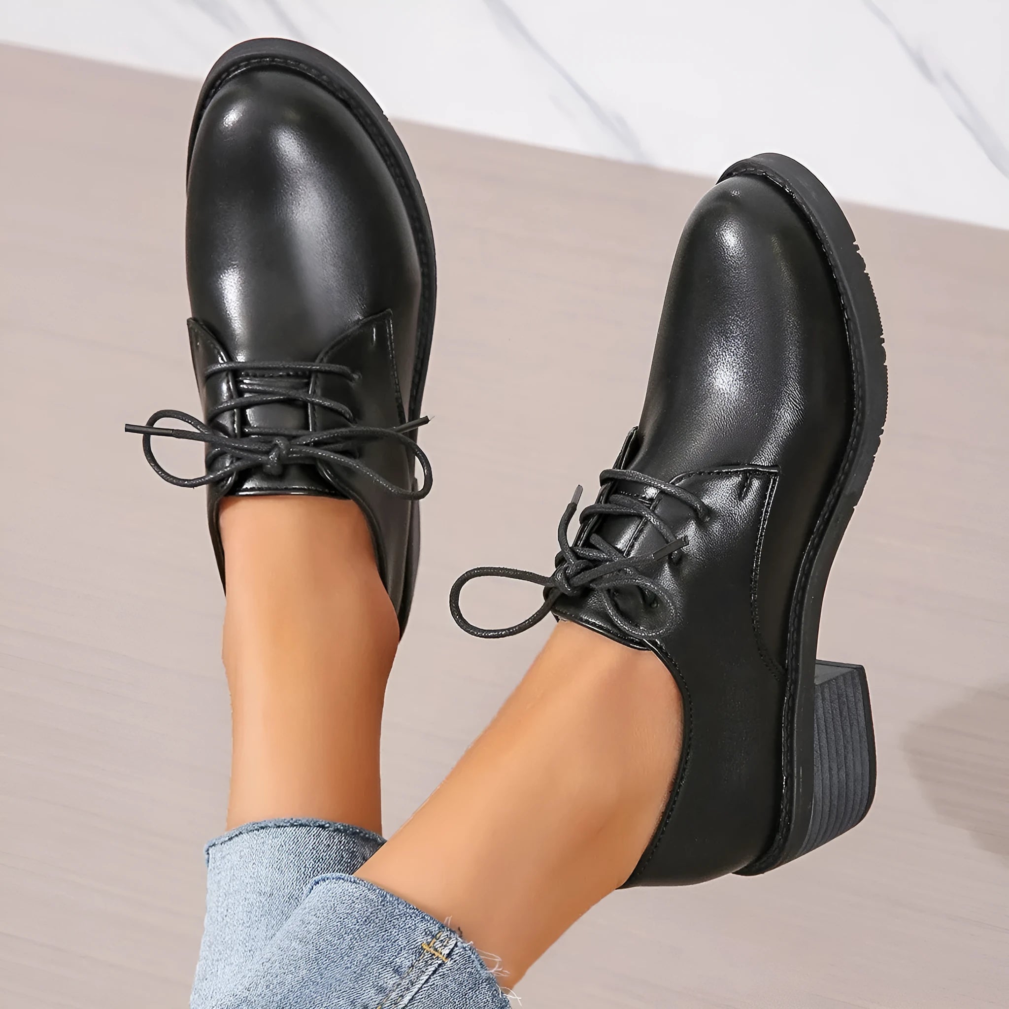 Black women's low-top work shoes with a thick chunky heel and rounded toe.