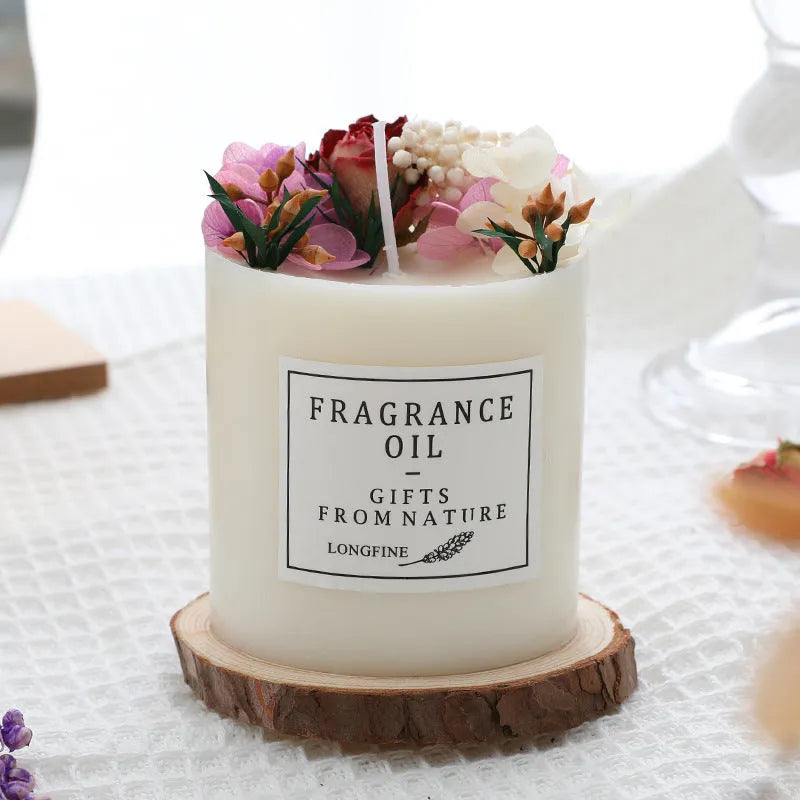 Aromatherapy candle with dried flowers embedded in wax, shown with optional wooden chip base and gift box.