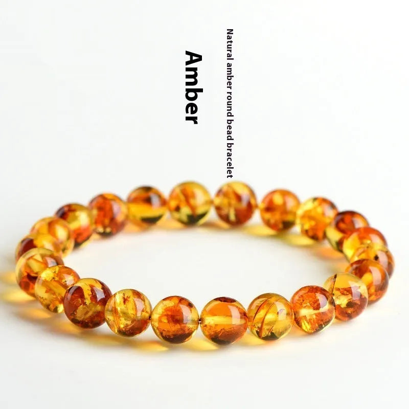 Natural yellow piebald amber bracelet with geometric beads on a white background.