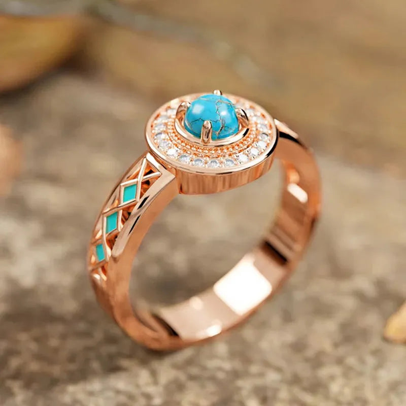 Women's rose gold coloured copper ring with geometric ethnic design and inlaid zircon detailing.