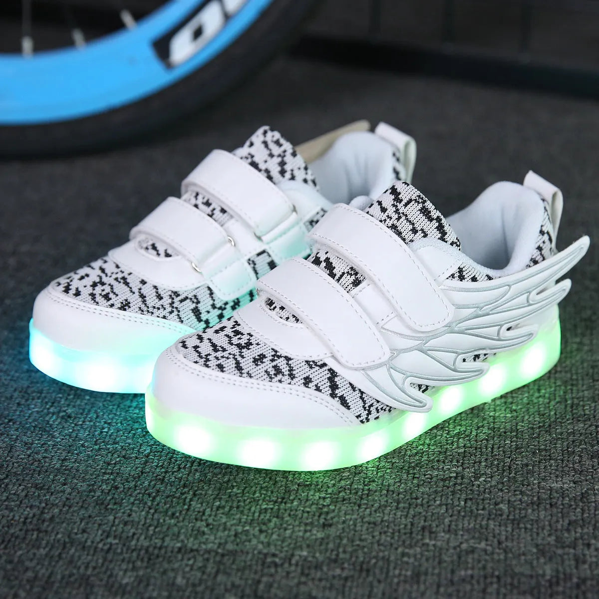 Children's plum red and white USB-rechargeable light-up sneakers with colourful LED lights.