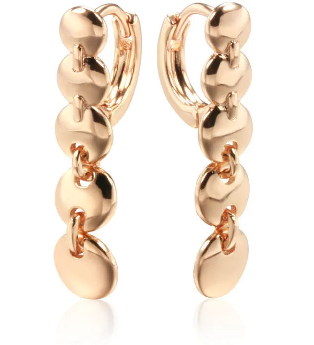 Gold tone retro earrings with a round circle shape and surface weave design, hanging as a dangle.