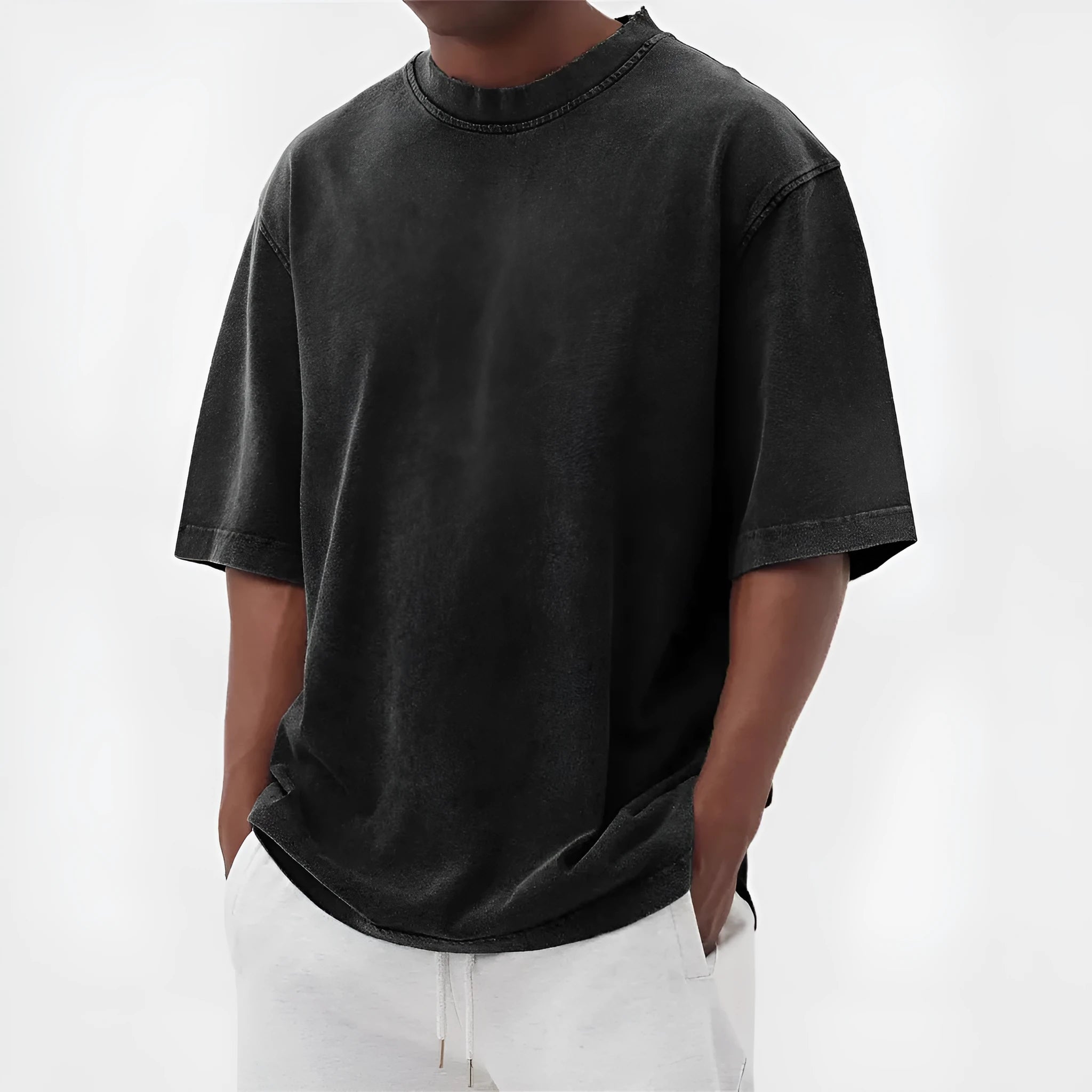 Man wearing a loose-fit distressed pullover T-shirt in a solid colour, showcasing the casual style and half-sleeve design.