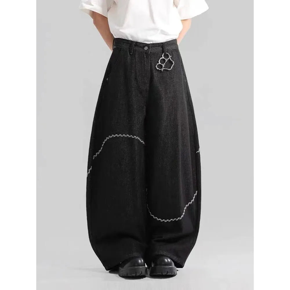 Black straight-leg denim trousers with mid-waist zip fly design on hanger