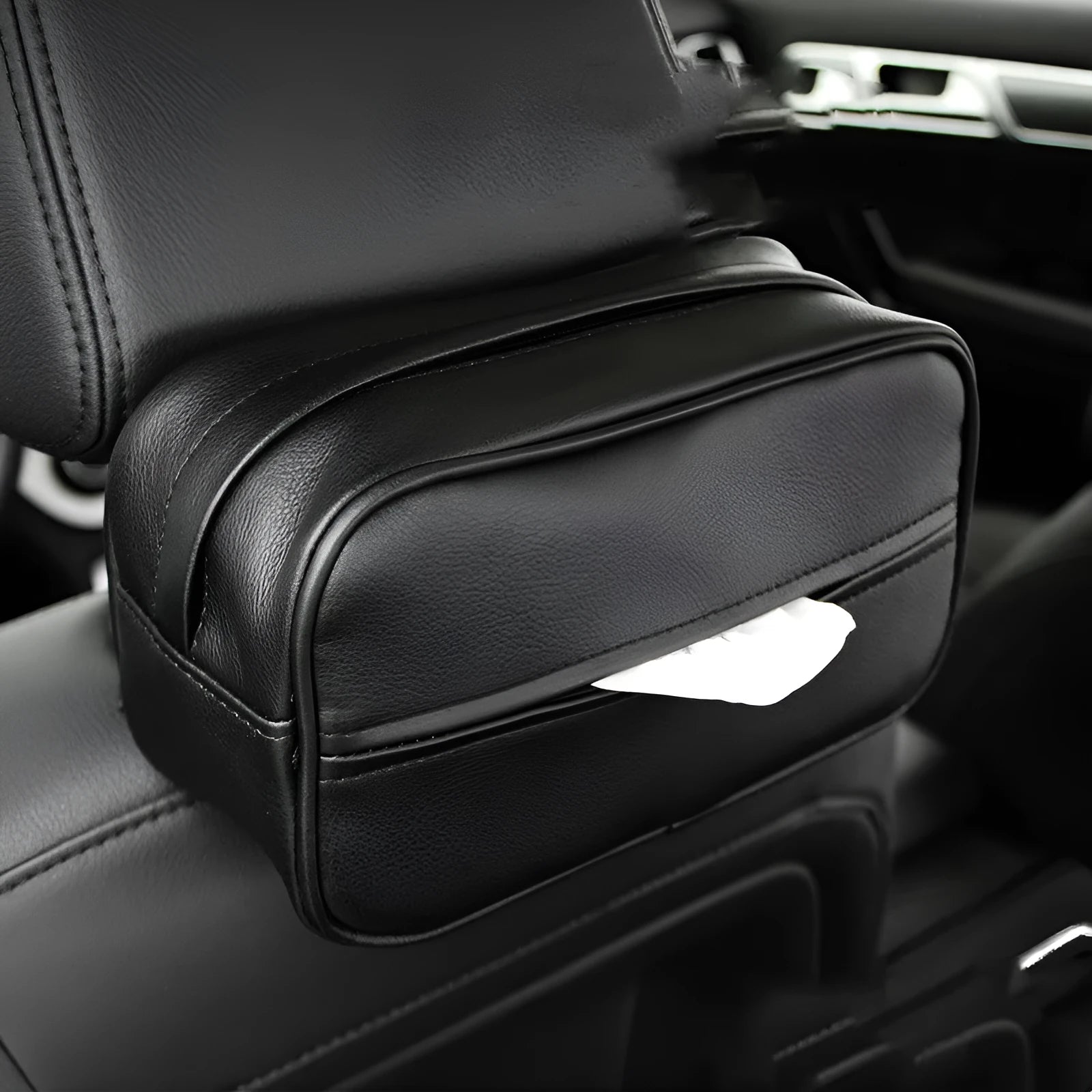 Black leather storage box with removable paper bag inside for car and home organisation.