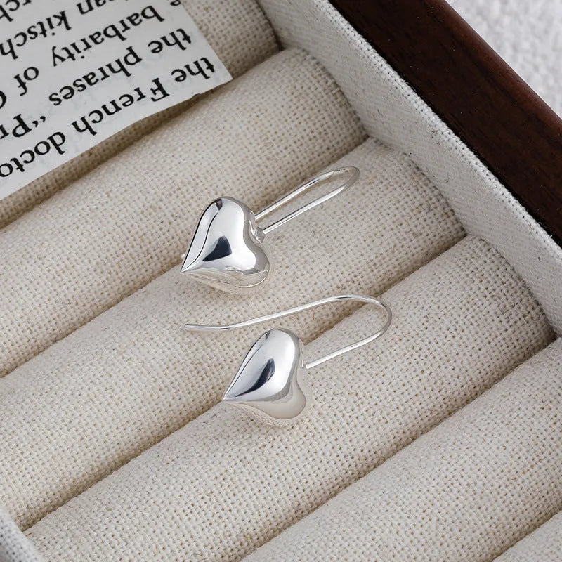 Silver-coloured heart-shaped earrings with 3D glossy design and Korean-style elements