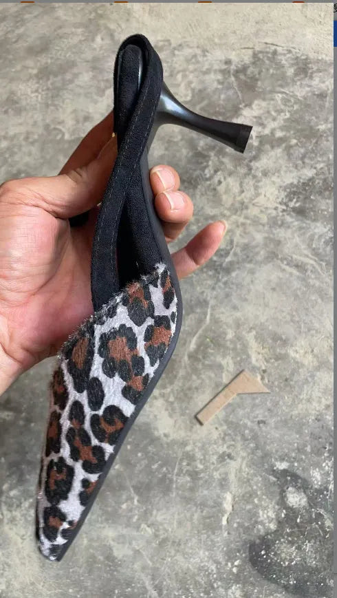 Leopard print suede women's sandals with pointed toe design on foot