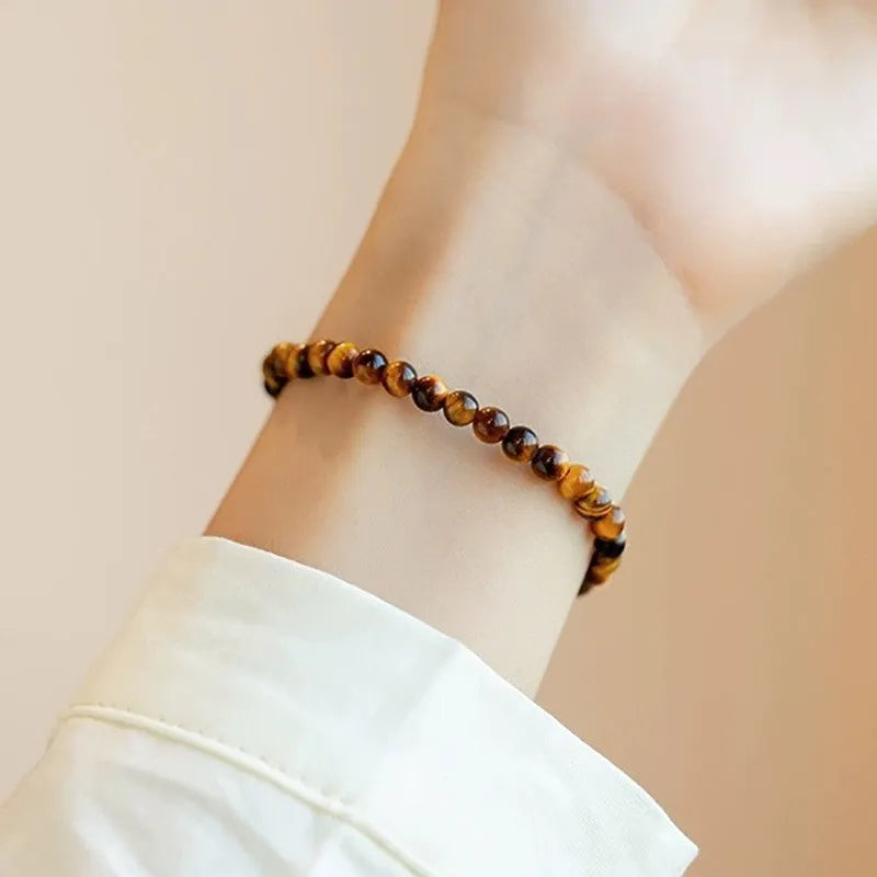Tigereye stone bracelet with geometric Chinese style design showing round bead elements