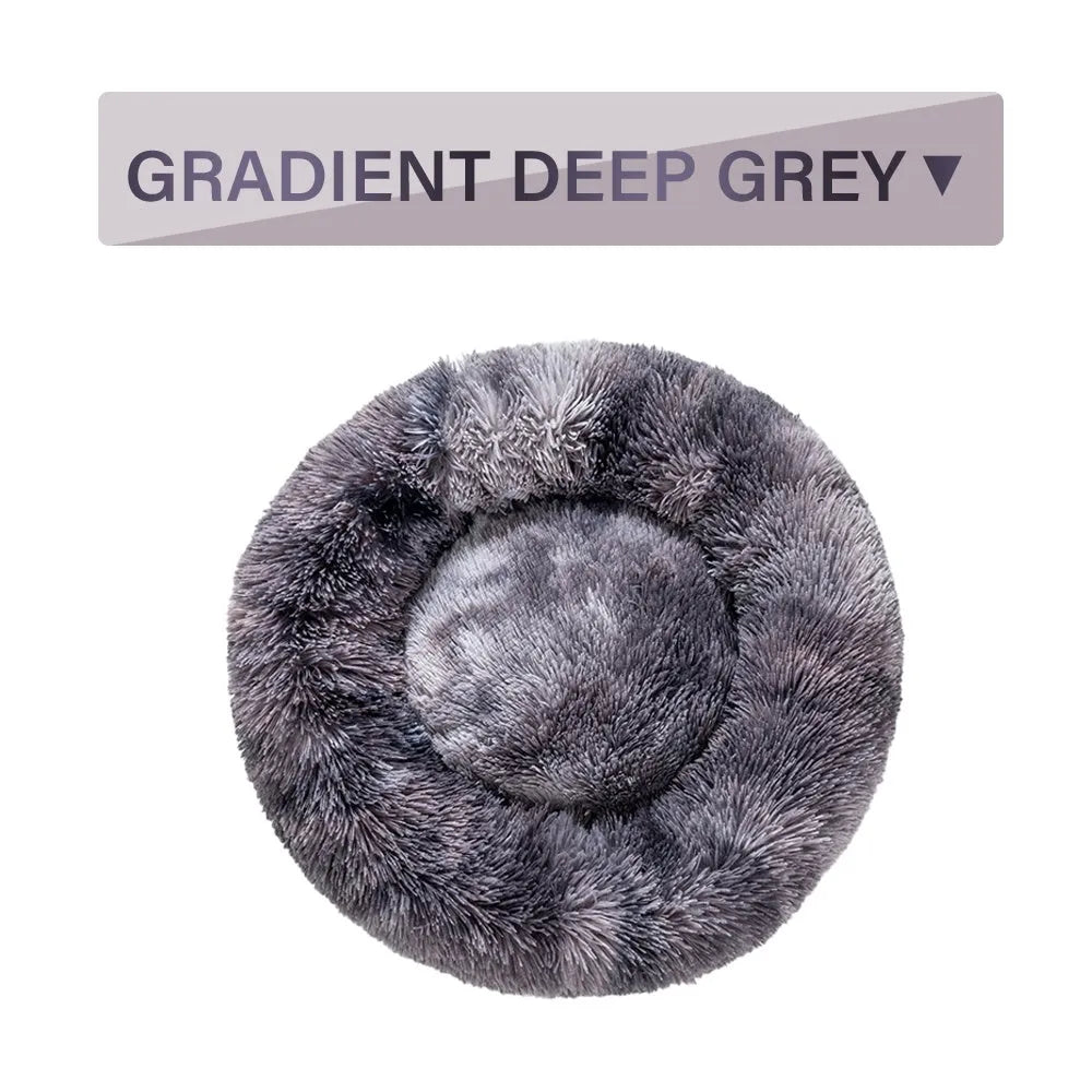 Fluffy grey donut dog bed with raised rim, shown with a small dog sleeping inside.