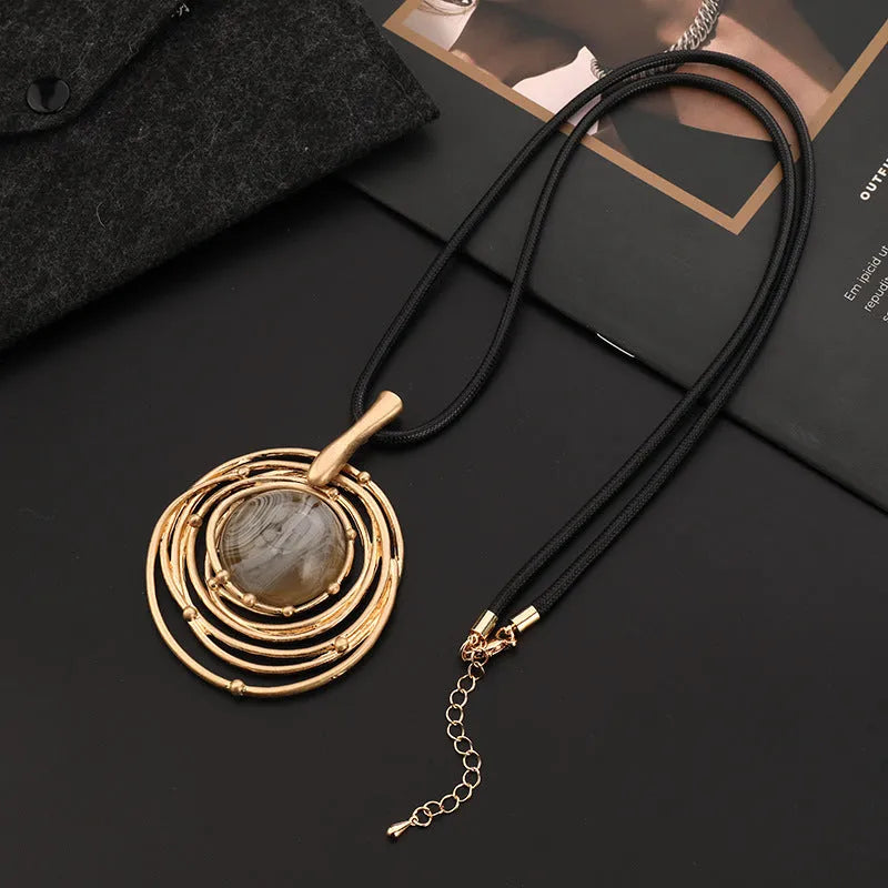 Vintage women's geometric sweater chain necklace with gold alloy pendant and snakeskin wax rope chain.