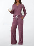 Women's striped knitted long coat with V-neck, long sleeves, lace-up detail, and side pockets.