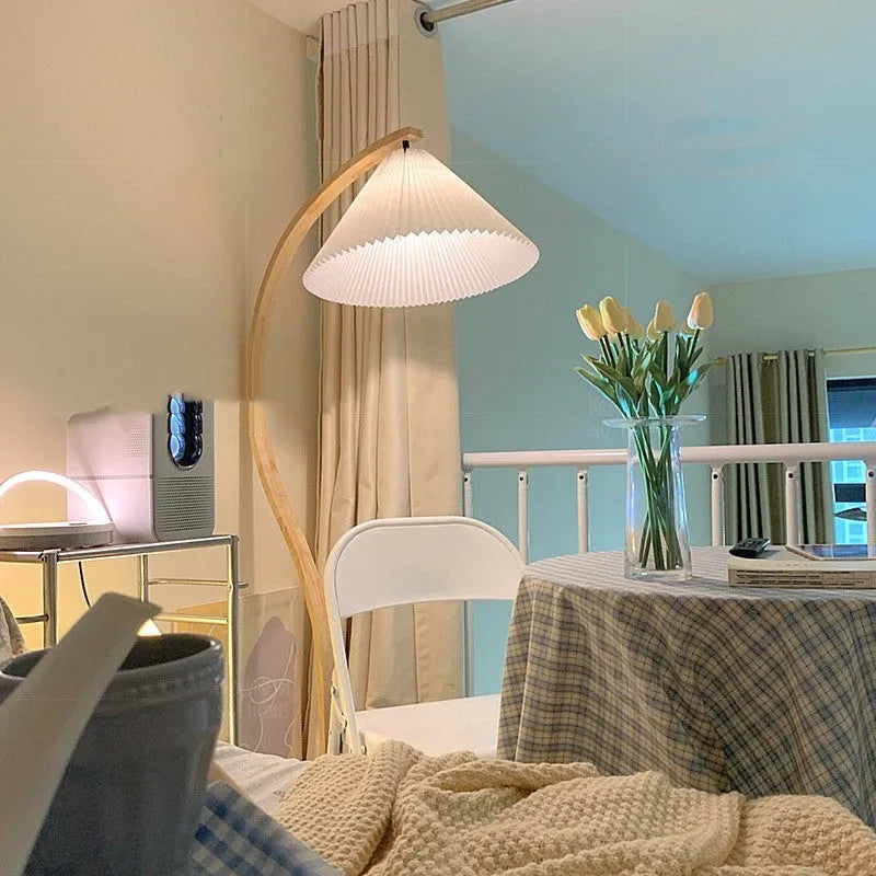 Retro vertical table lamp with fabric shade in choice of colours beside a sofa.